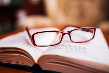 stack of books with glasses