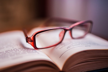 stack of books with glasses