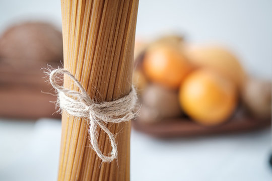 Detail view of brown spaghetti pasta on kitchen table. Selective focus.