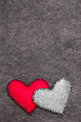 Felt hearts on gray background, copy space