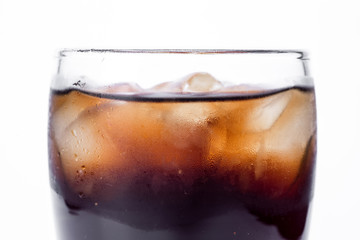 Ice cola with splashing, bubbles. Drink with ice.