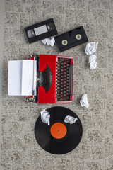 Equipment single journalists. Old typewriter, crumpled paper, video tapes, cassettes and beta dv...