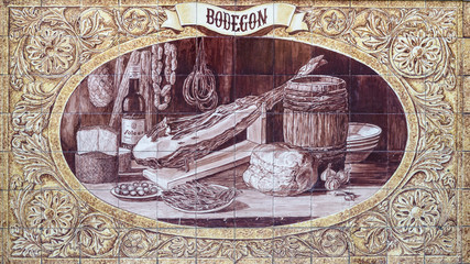 Tiled mural from Triana area, Seville, Andalucia, Spain. Mural depicting Inberian ham and condiments © Doug Armand