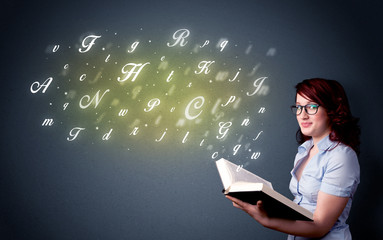 Young lady holding book with letters