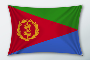 Fototapeta premium Eritrea national flag. Symbol of the country on a stretched fabric with waves attached with pins. Realistic vector illustration.