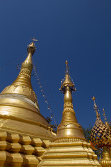 Fototapeta premium Amazing golden stupa, chedi and pagoda in buddhist temple in Thailand with deep blue sky background