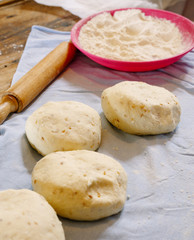 Pita dough with rolling pin..