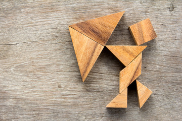 Tangram puzzle in man hold umbrella (Concept for business about face the crisis)