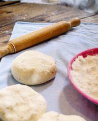 Fototapeta na wymiar Pita dough with rolling pin..