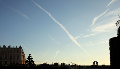 Traces in the sky at sunset from the aircraft over Versailles