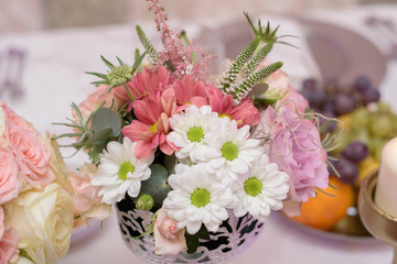 Arrangement for table with flowers and fruits