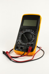 Digital multimeter with probes on the white background