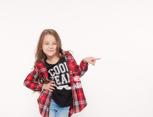 school girl pointing with finger away isolated on white.