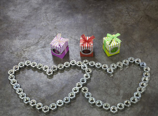 Two nut heart and three gift on the metal background for valenti