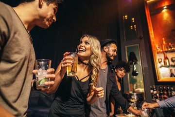 Group of people having fun at nightclub - obrazy, fototapety, plakaty