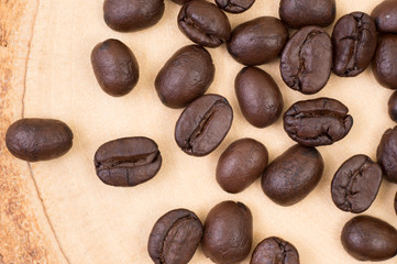 Top view of roasted coffee bean on wood texture background