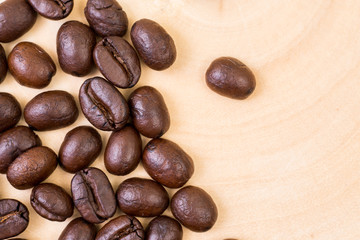 Top view of roasted coffee bean on wood texture background