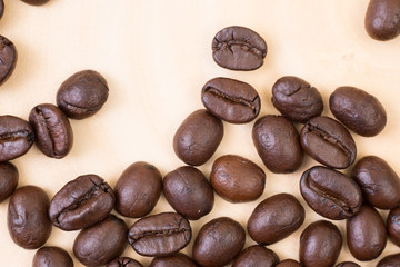 Top view of roasted coffee bean on wood texture background