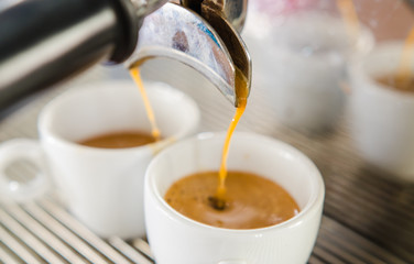 Barista making a cup of coffee soft focus image .