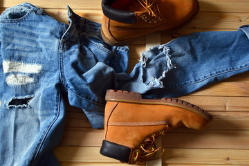 Heavy yellow boots and ragged blue jeans