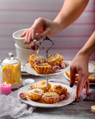 Hand decorated with roses a stand with lemon cupcakes