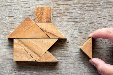 Wooden tangram puzzle wait to fulfill home shape for build dream