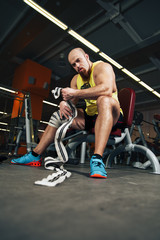 Fototapeta na wymiar Man rests in gym after having a workout