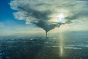 Air pollution smoke from pipes and factory with winter background