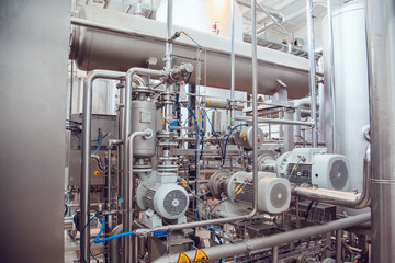 Modern beer plant, with brewing kettles, vessels, tubs and pipes made of stainless steel. Brewery.