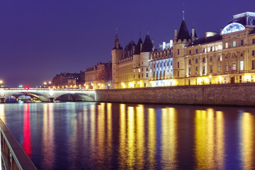 Fototapeta na wymiar Embankment of the Seine, the Ile de la Cite and Conciergerie at night, Paris, France