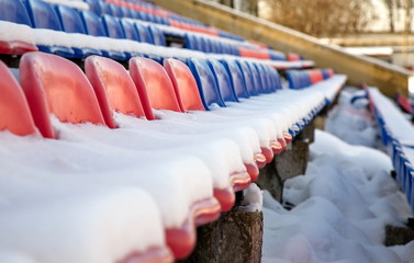 Seats in the stadium under the snow.