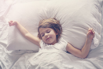 Cute little girl in bed.