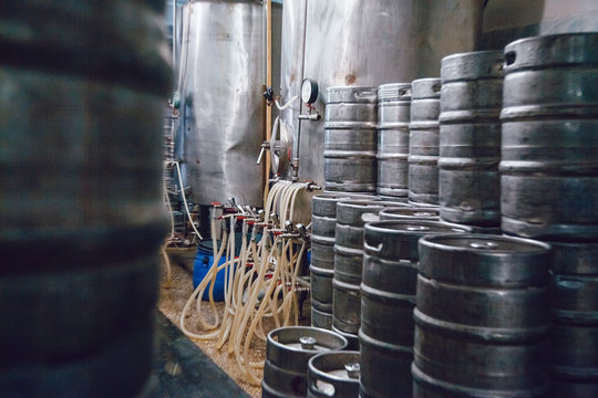 Metal beer kegs stand in beer plant. Brewery.