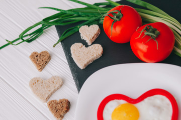 valentine day.romantic breakfast.Fried eggs with vegetables