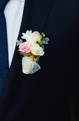Beautiful groom's wedding boutonniere on the jacket