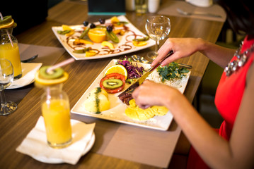 Woman having dinner in restaurant.