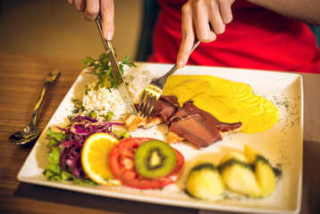 Woman having dinner in restaurant.