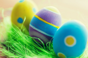 close up of colored easter eggs and grass
