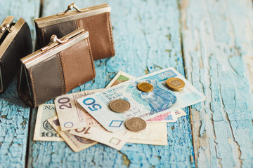 Polish zloty with a wallet on the wooden background