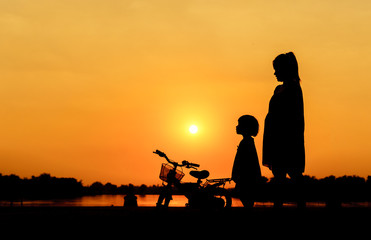 Fototapeta na wymiar Bike family silhouette mother and daughter