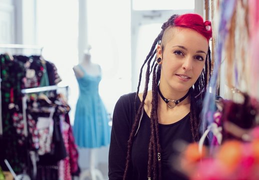 Female hairdresser in dreadlocks shop