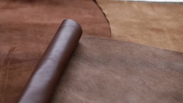 two rolls of brown leather rolling on the surface of the skin