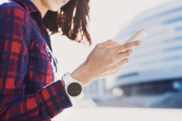 Beautiful young woman using smartphone in the city