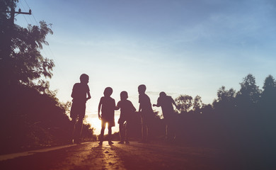 Fototapeta na wymiar silhouette of friends jumping in sunset,friendship concept.