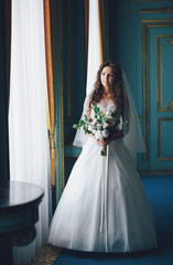 Fototapeta premium Portrait of the lovely bride in the blue room