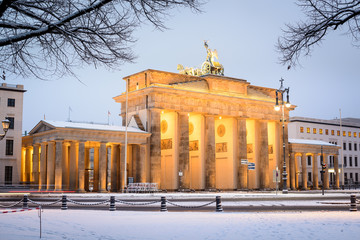 illuminated Brandenburg gate (Brandenburger Tor) and 18th of March Square in snow, Berlin, Germany,...