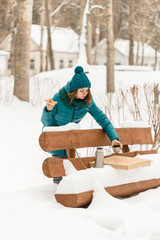 Girl eating pizza in the cold winter