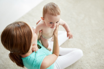 happy young mother with little baby at home