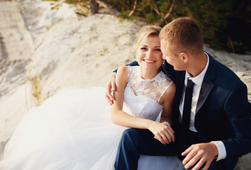 Sincere smile of the bride next to the groom