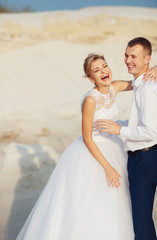 Laugh of newlyweds in the sunny desert